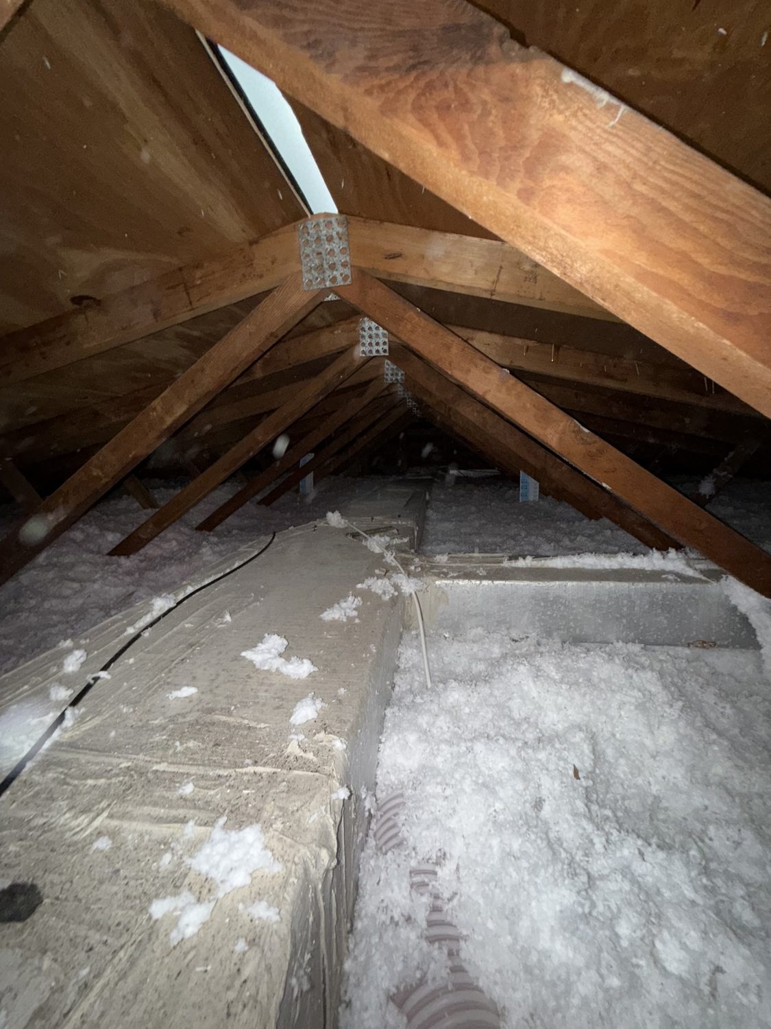 Blown-in attic insulation topped off over ductwork
